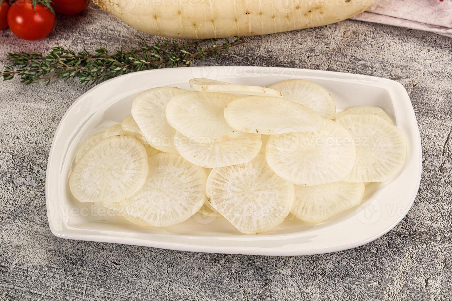 A white plate with sliced potatoes and tomatoes photo