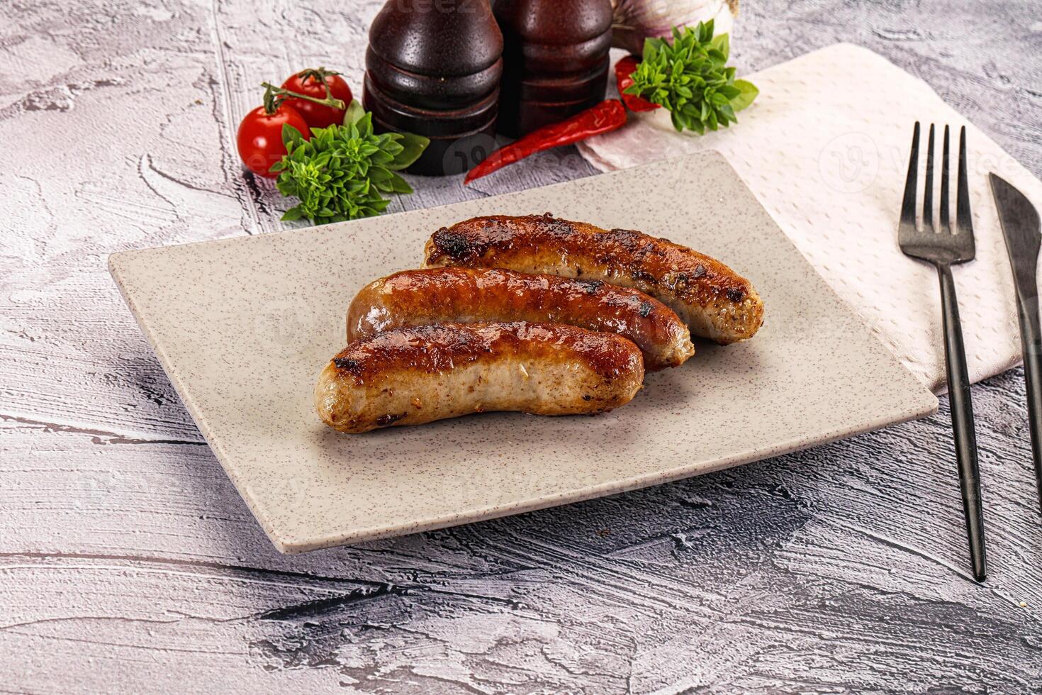 A plate with three sausages on it photo