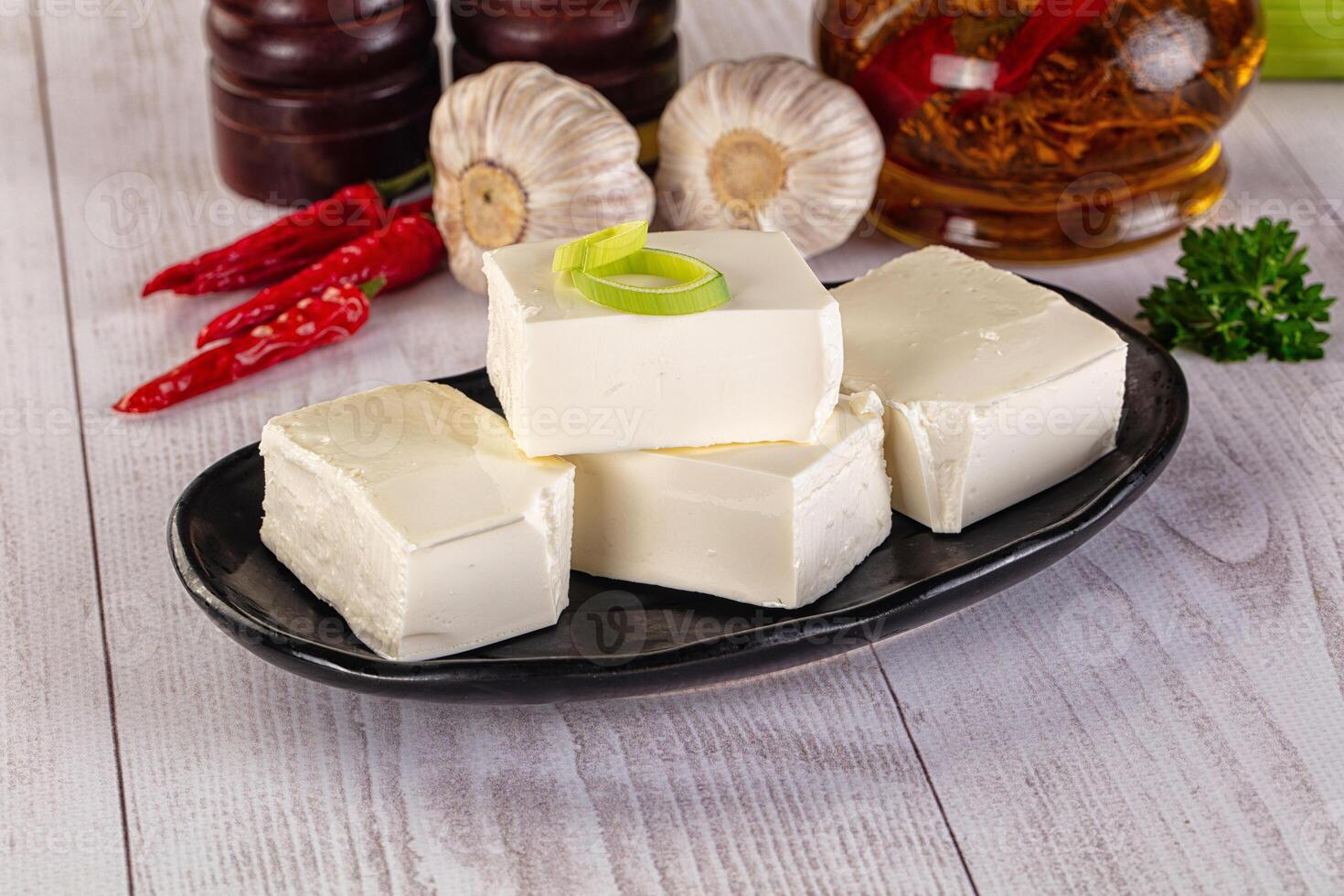 A plate of tofu with a green pepper and garlic photo