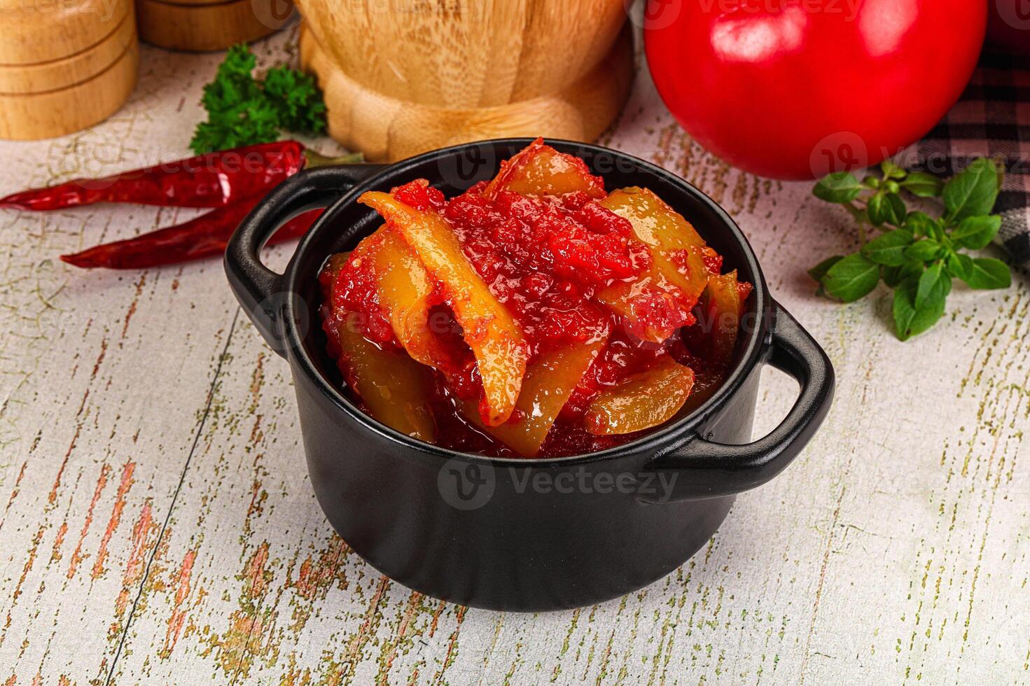 A black pot filled with food on a table photo