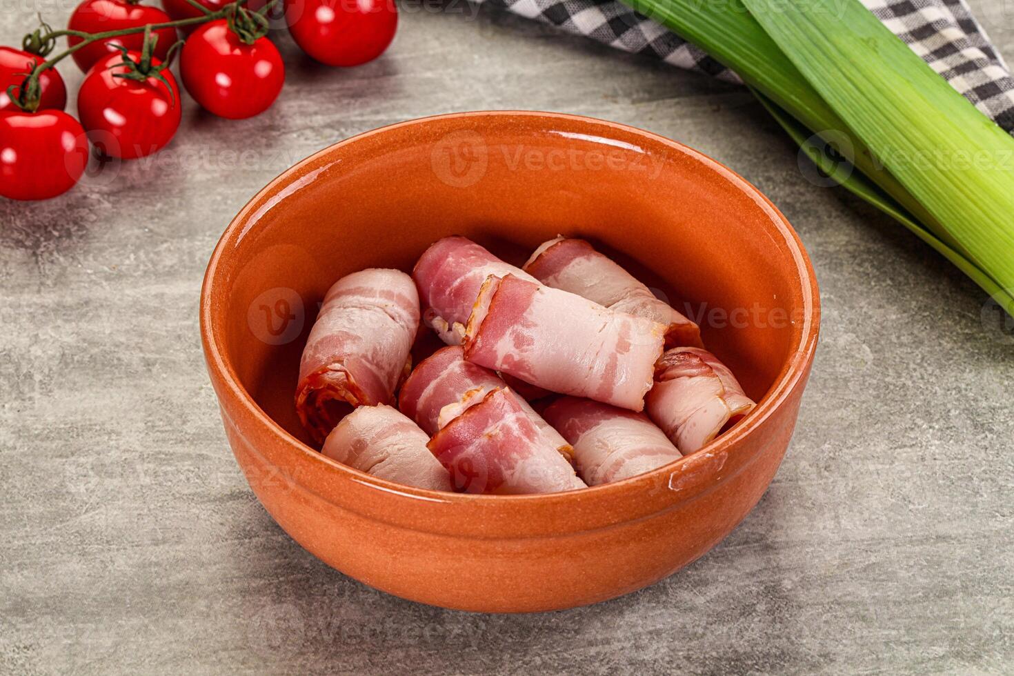 A bowl filled with bacon and tomatoes photo