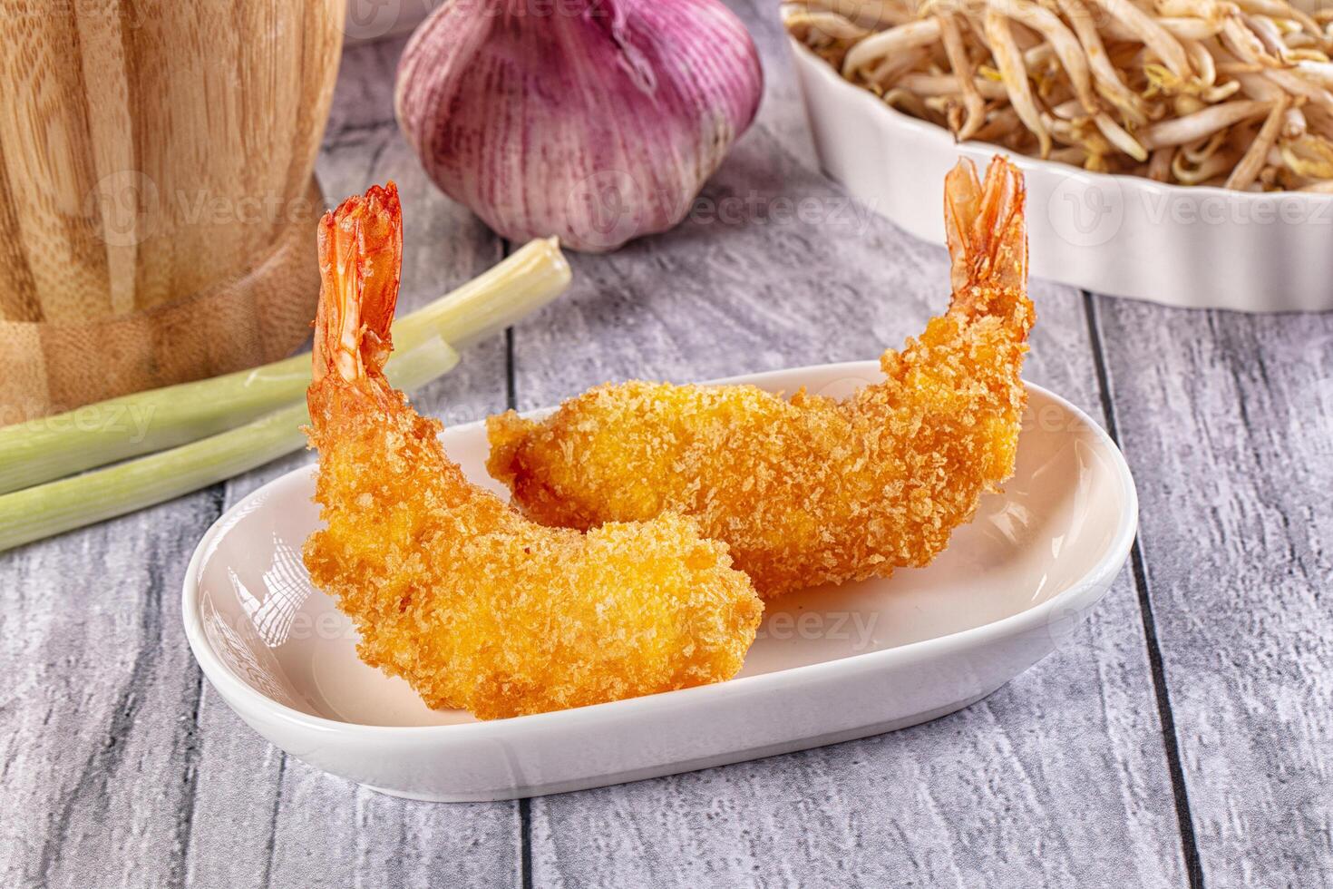 Two fried shrimp on a plate with a bowl of rice photo
