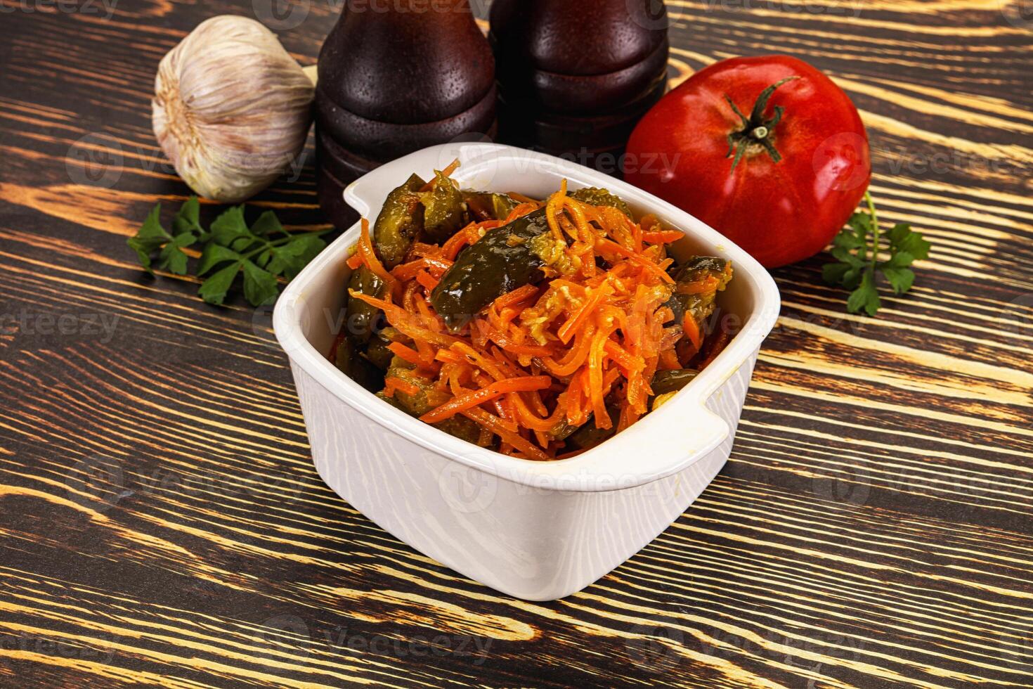 A white bowl with vegetables and a bottle of ketchup photo