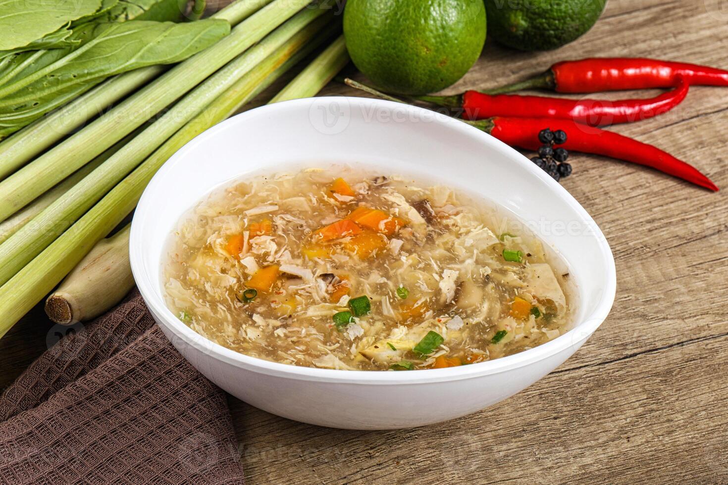 A bowl of soup with vegetables and a pepper photo