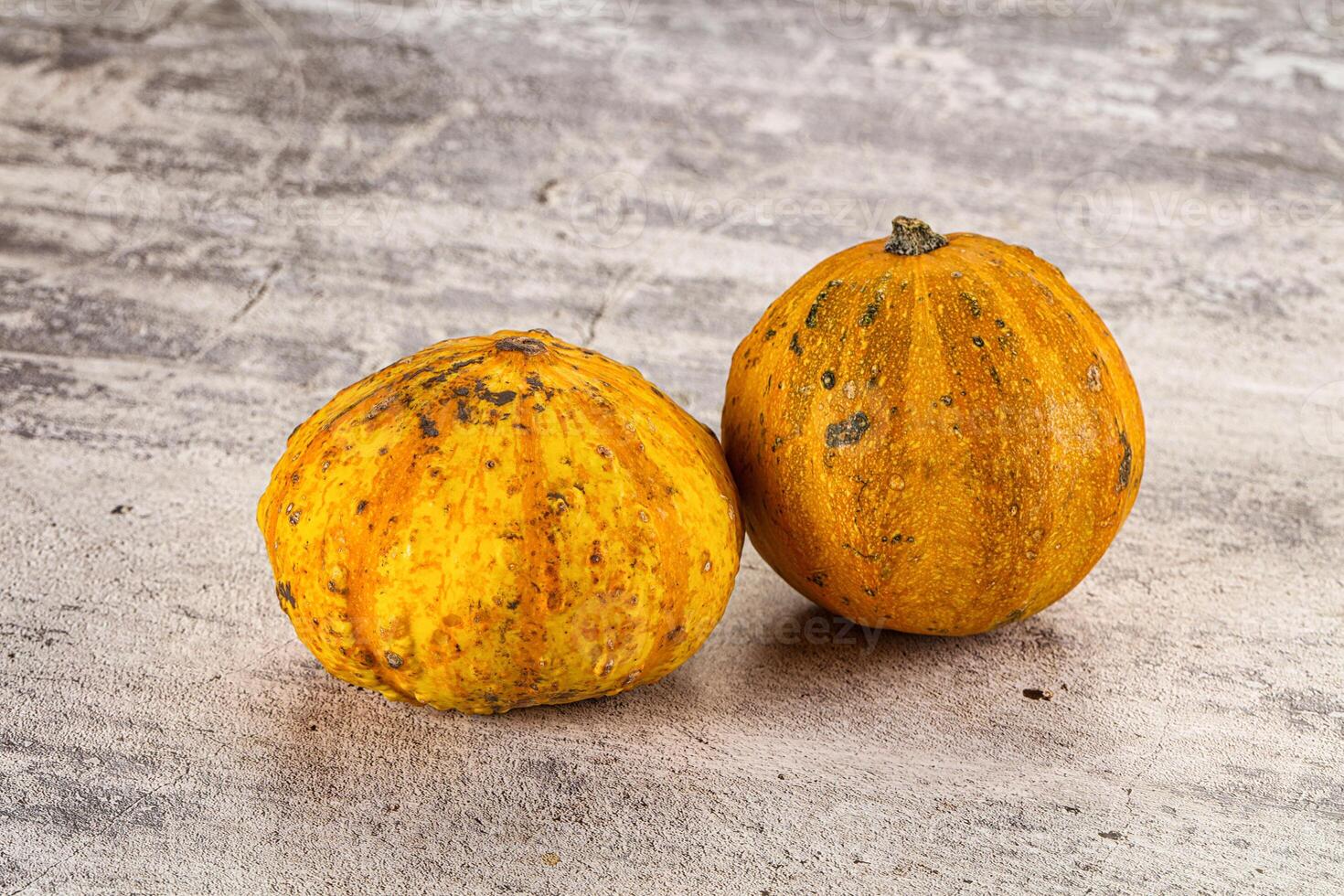 Two small yellow squash on a table photo