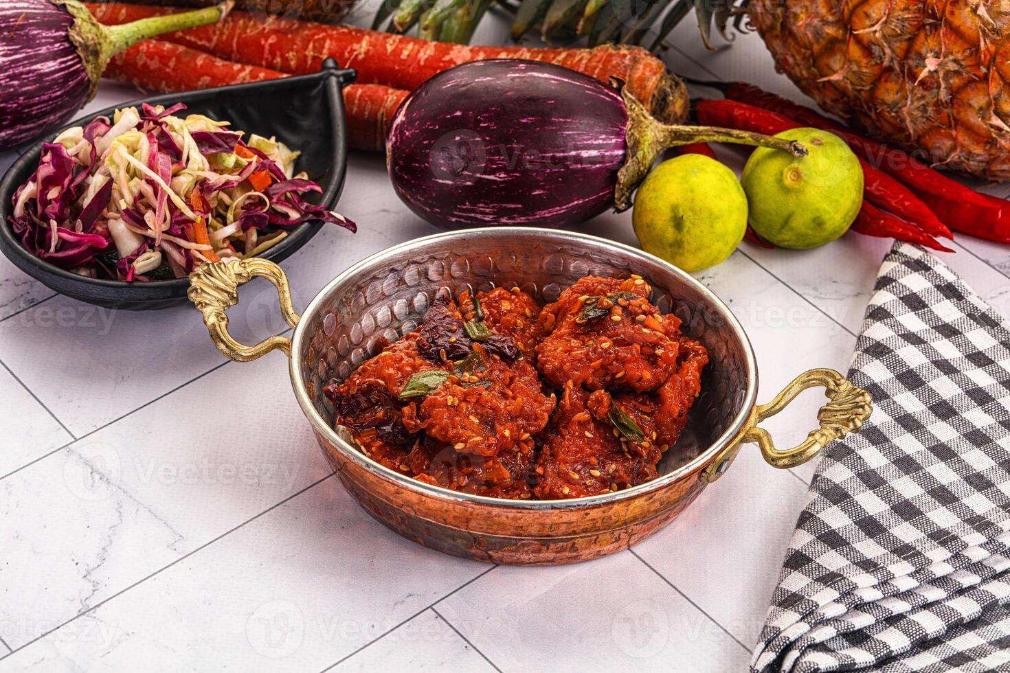 A bowl of food with vegetables and fruit on a table photo