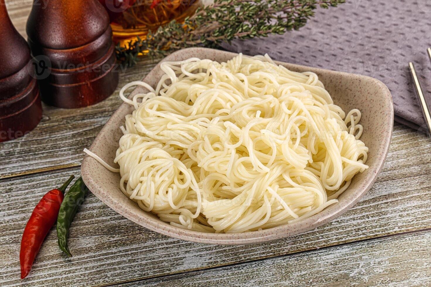 Chinese noodles in a bowl on a wooden table photo