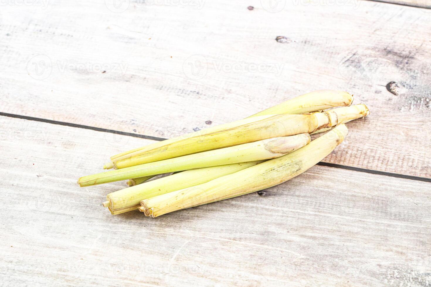 A pile of fresh green stalks on a wooden table photo