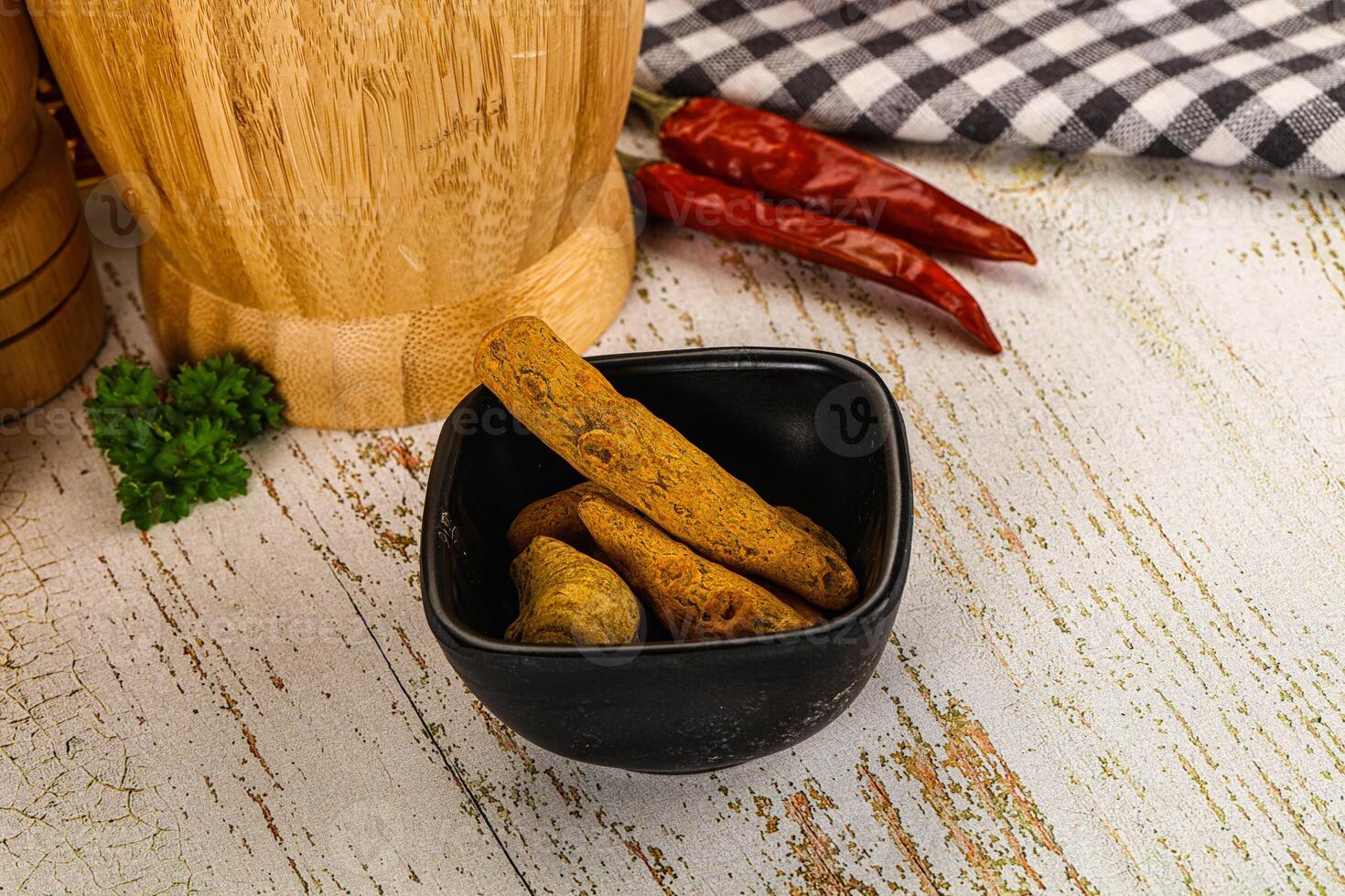 A wooden cutting board with a bowl of vegetables photo