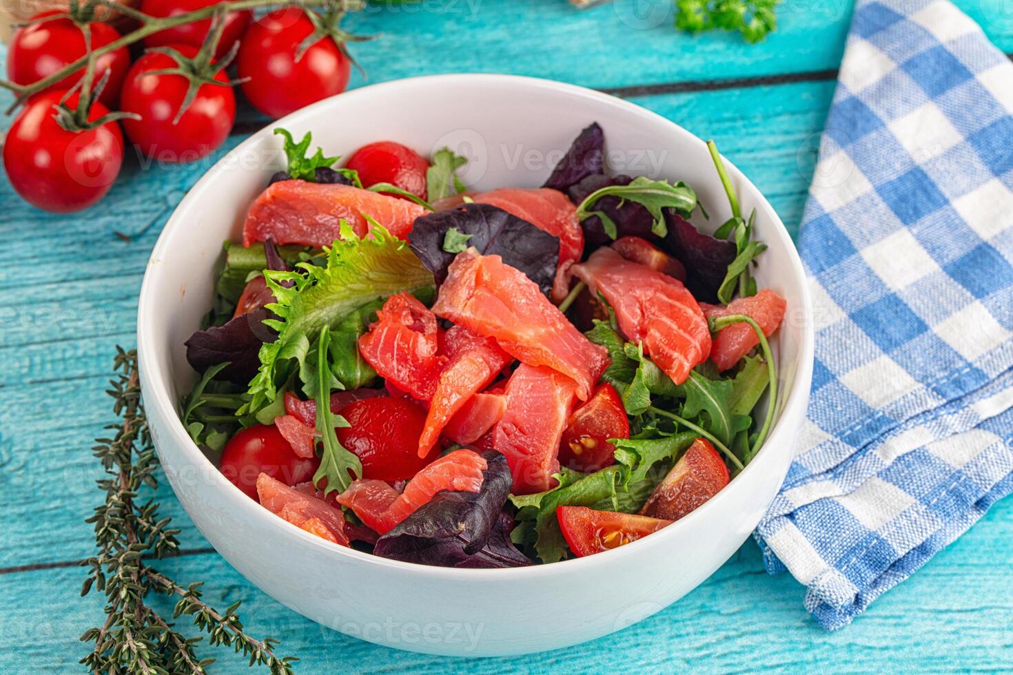 Salad with salmon, tomatoes and arugula photo