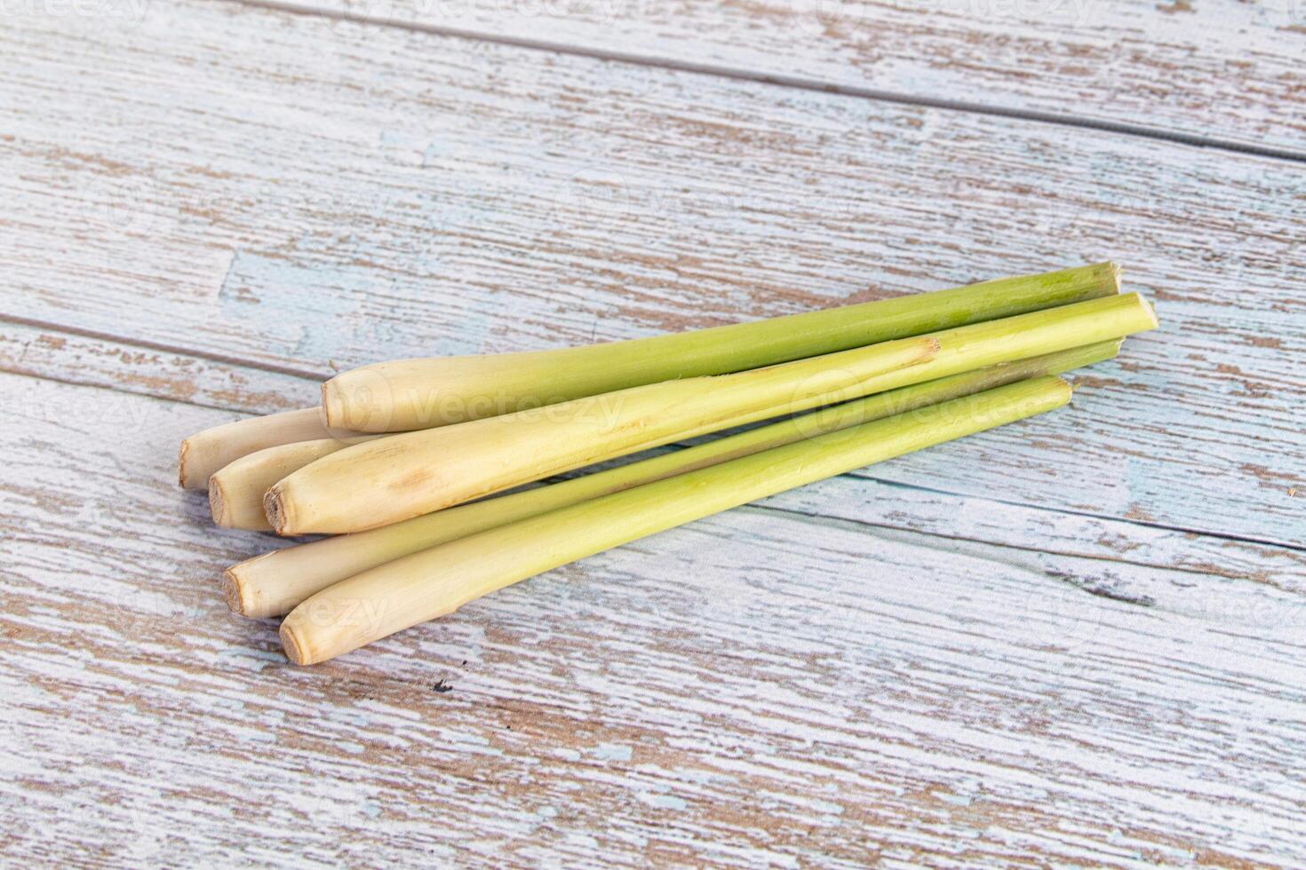 A bunch of green leeks on a wooden table photo