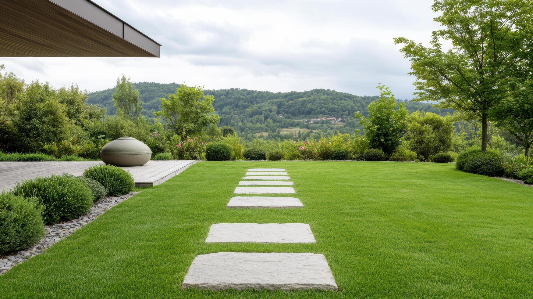 Lush green lawn with stone pathway leading to modern structure, surrounded by trees and hills photo