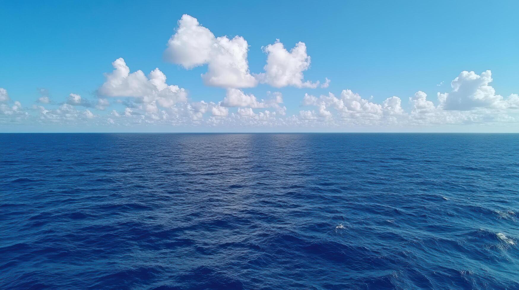 A view of the ocean from above with clouds in the sky photo