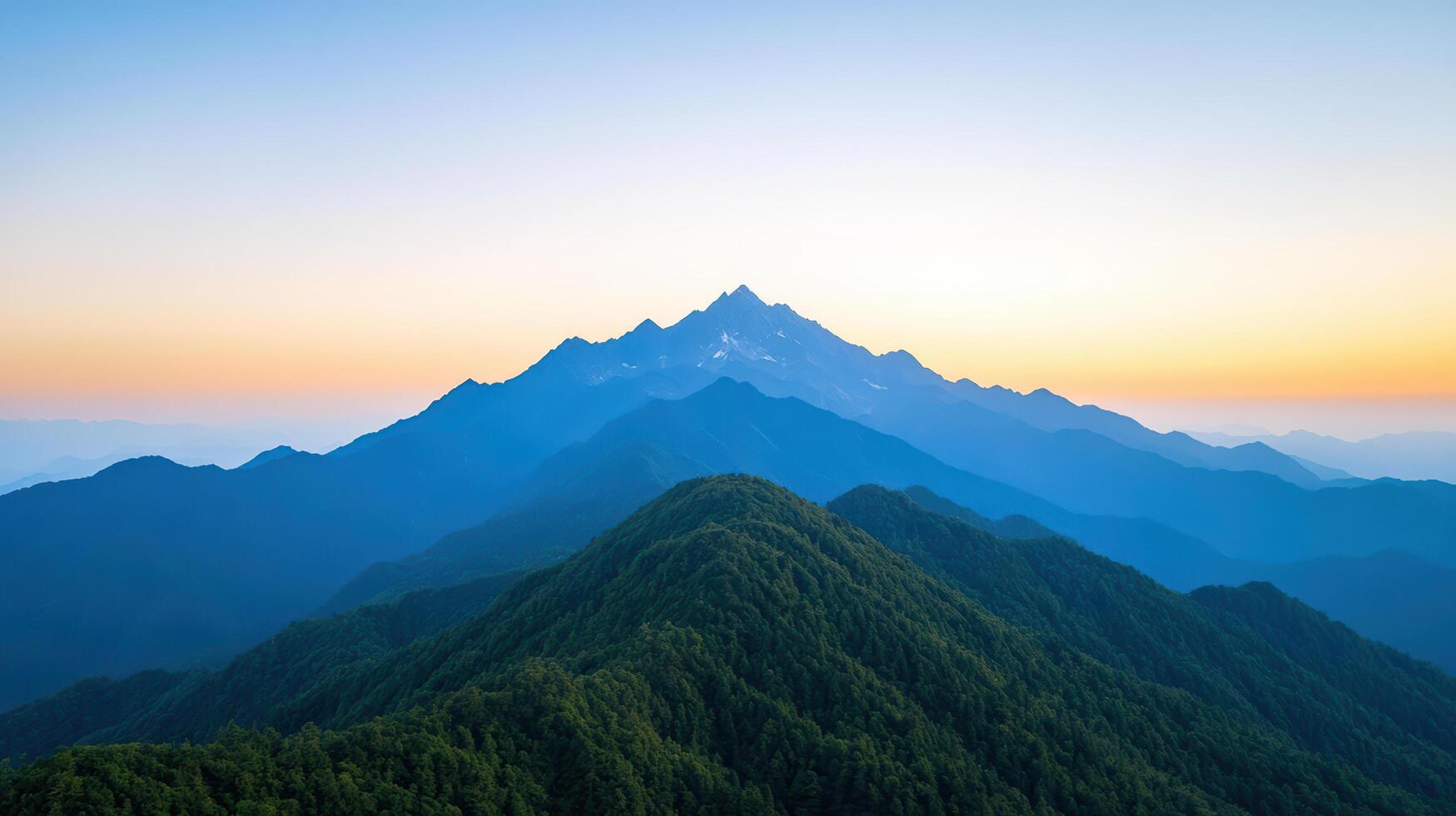 A mountain range with a blue sky and a sunset photo
