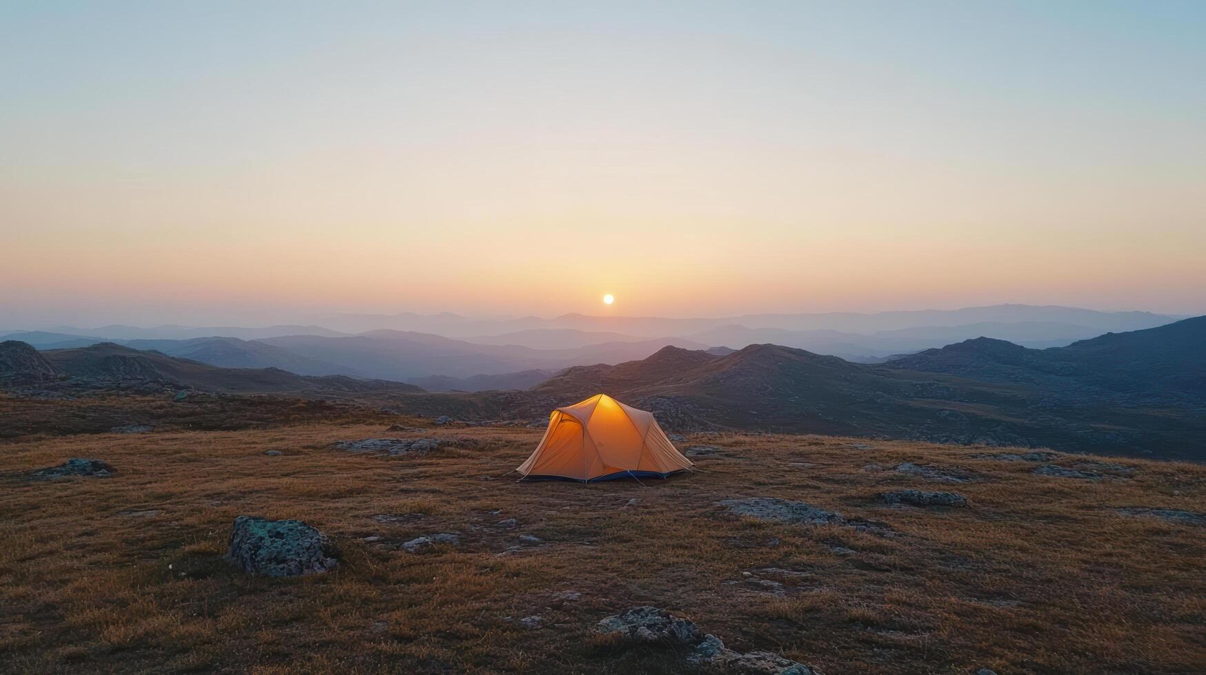Camping tent on the mountain at sunset photo