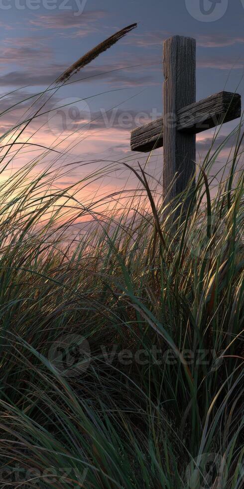 Sunset over tall grass with wooden cross in quiet landscape photo