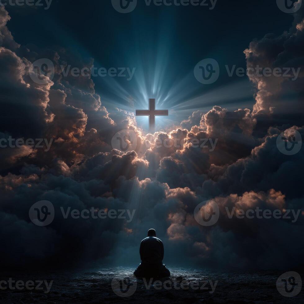 Man meditating under a cross in a dramatic cloudscape photo