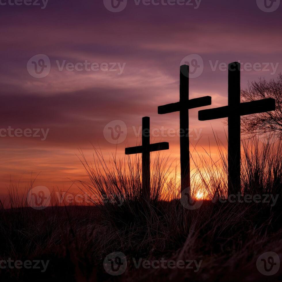 Three crosses are silhouetted against a sunset photo