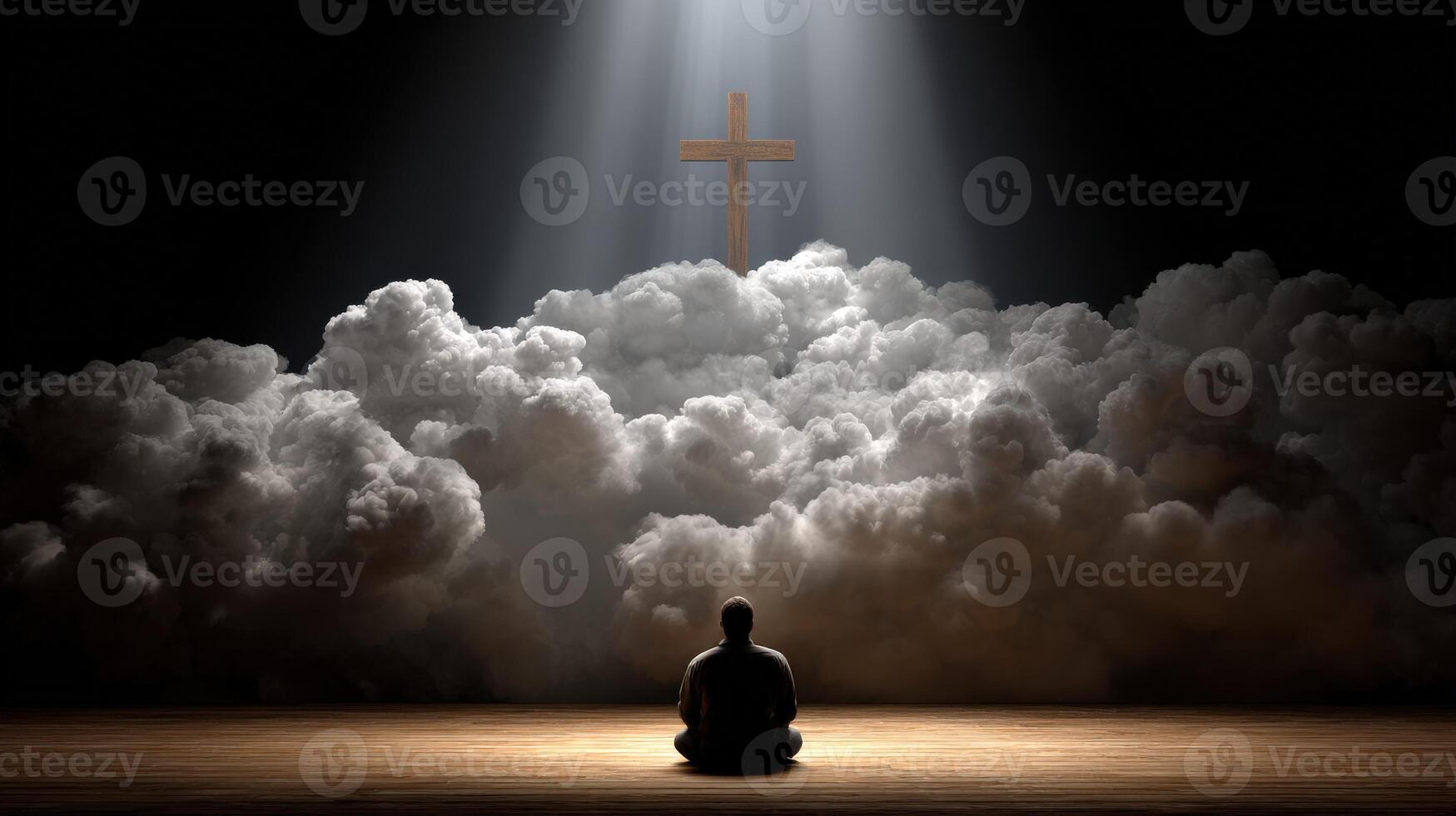 Man meditating under light with a cross in the background photo