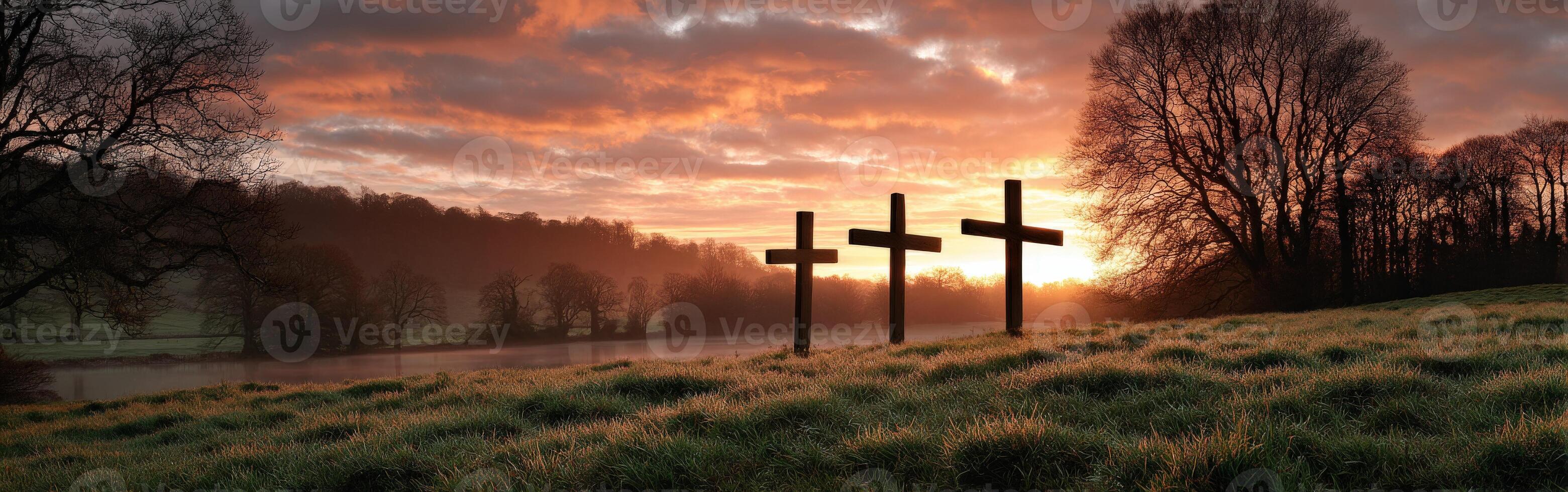 Three crosses are on a hill in front of a river photo