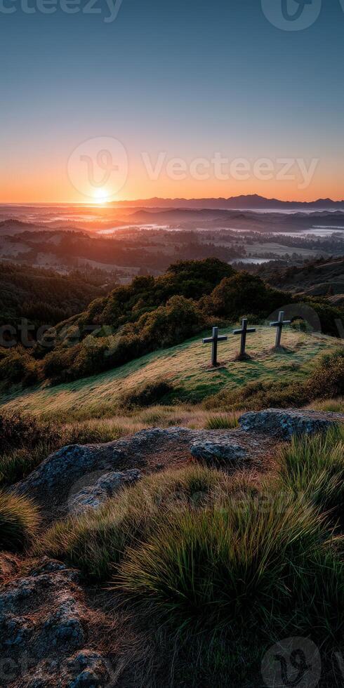 Sunset view over rolling hills with wooden crosses in foreground photo