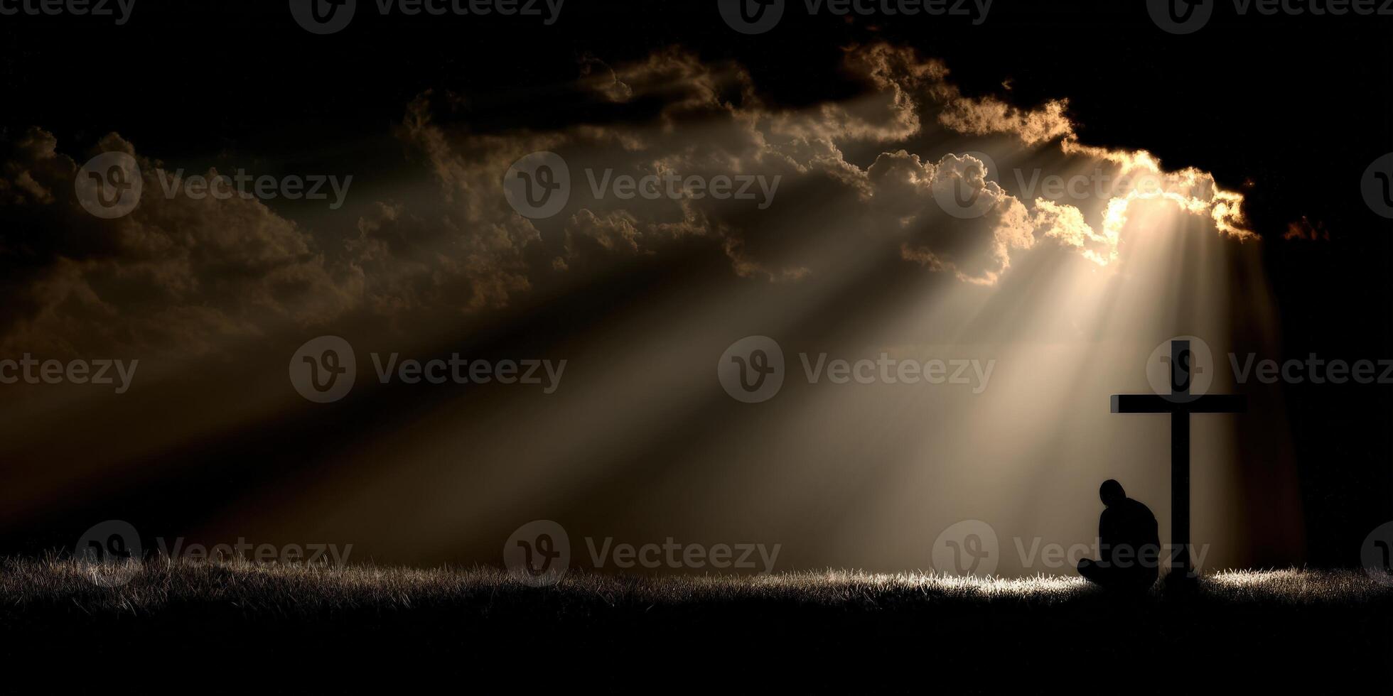 Solitary figure kneeling near a cross under dramatic clouds photo