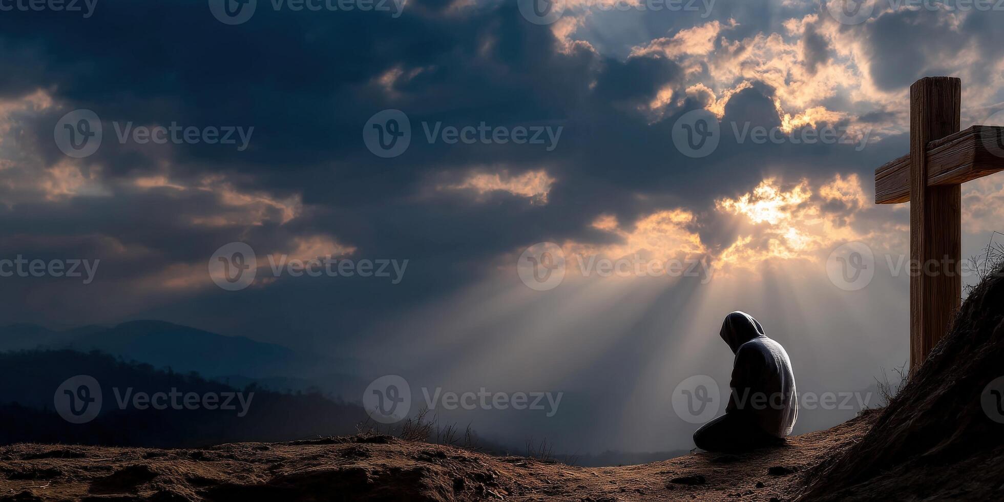 Contemplation at sunset near a cross on a serene hillside photo
