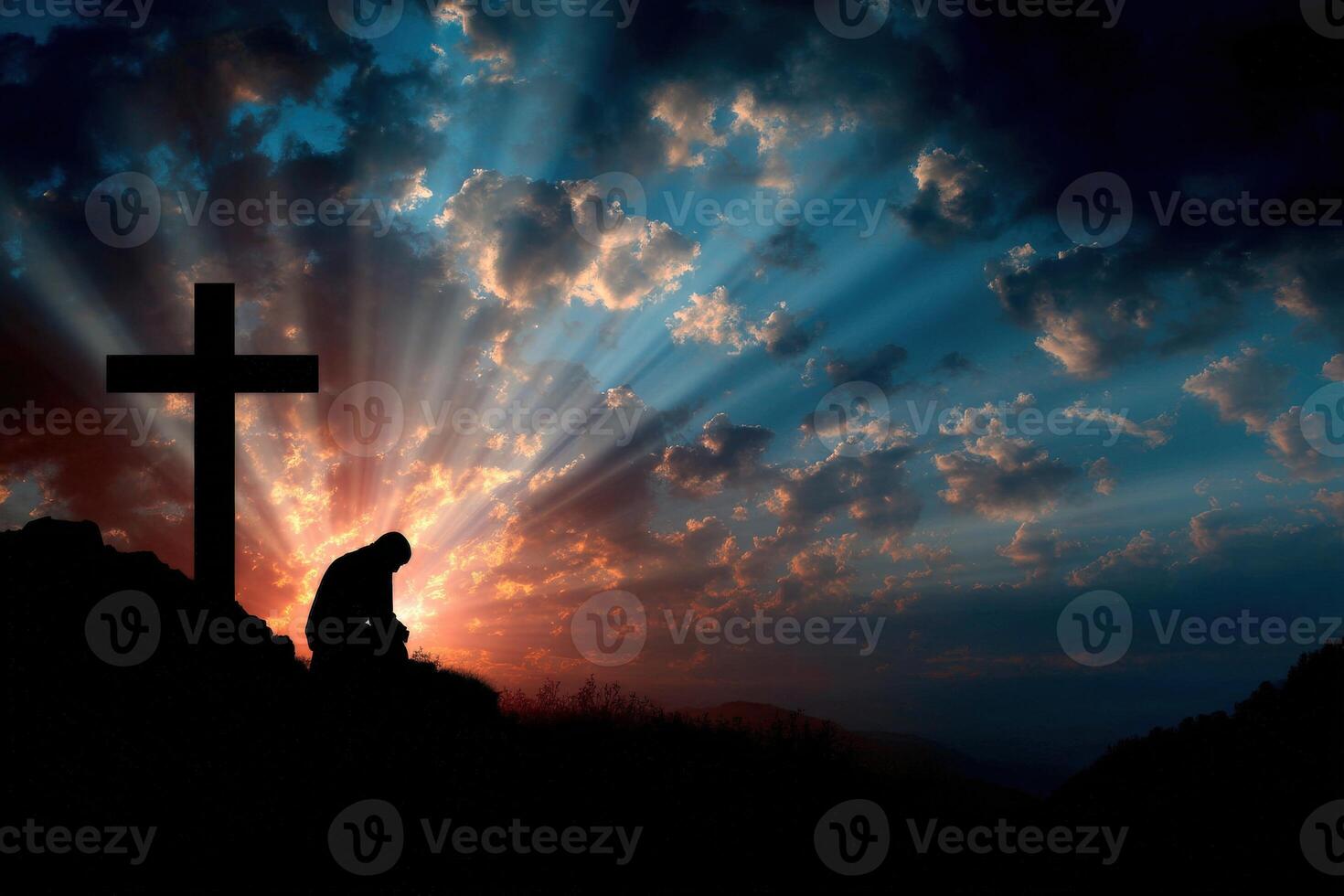 Silhouette of a person praying at sunset near a cross photo