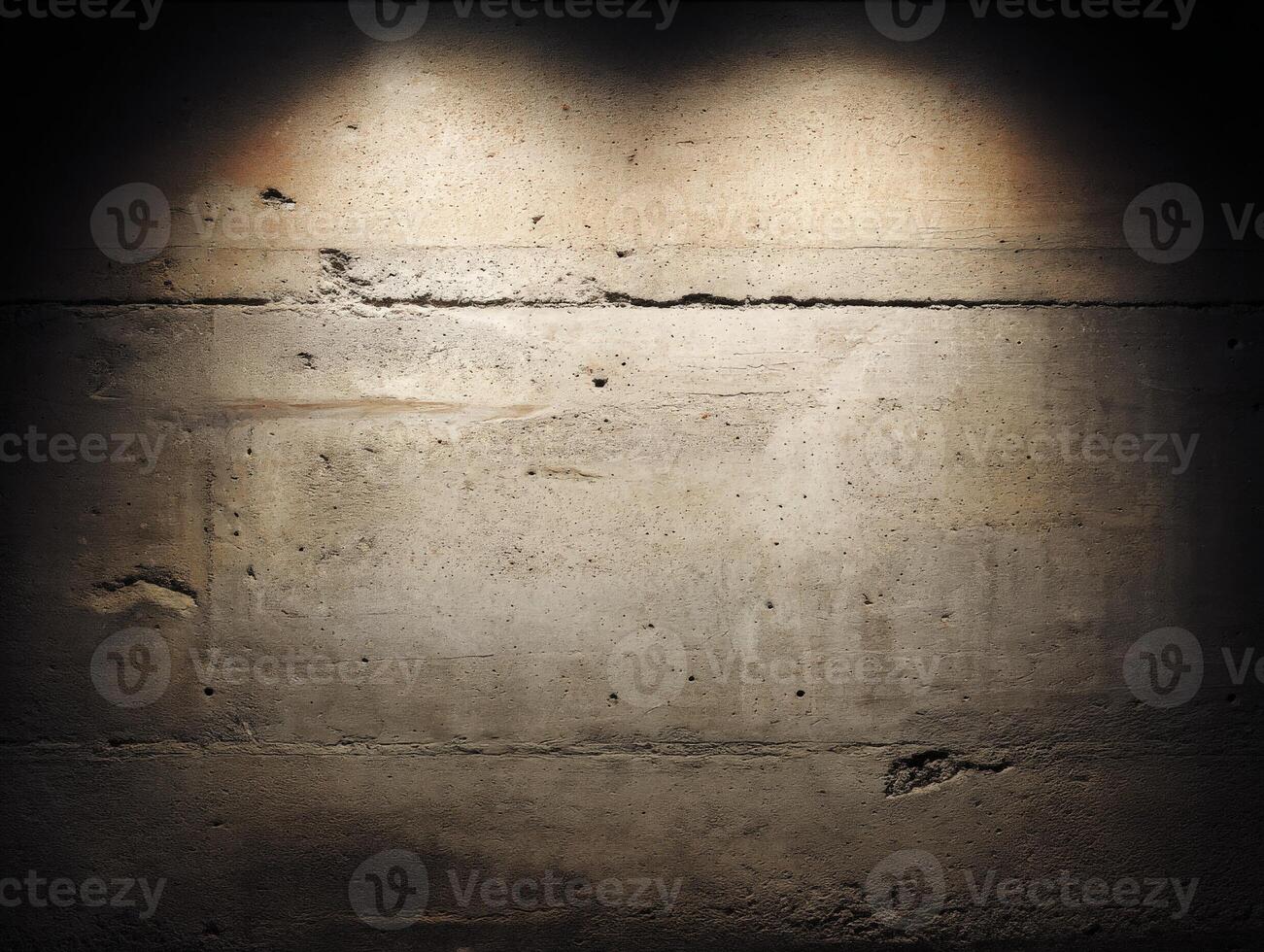 Concrete wall illuminated by ambient lights in a dark space photo