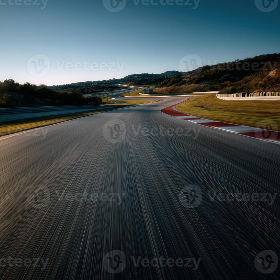 Racing track curves through hilly landscape at sunset photo