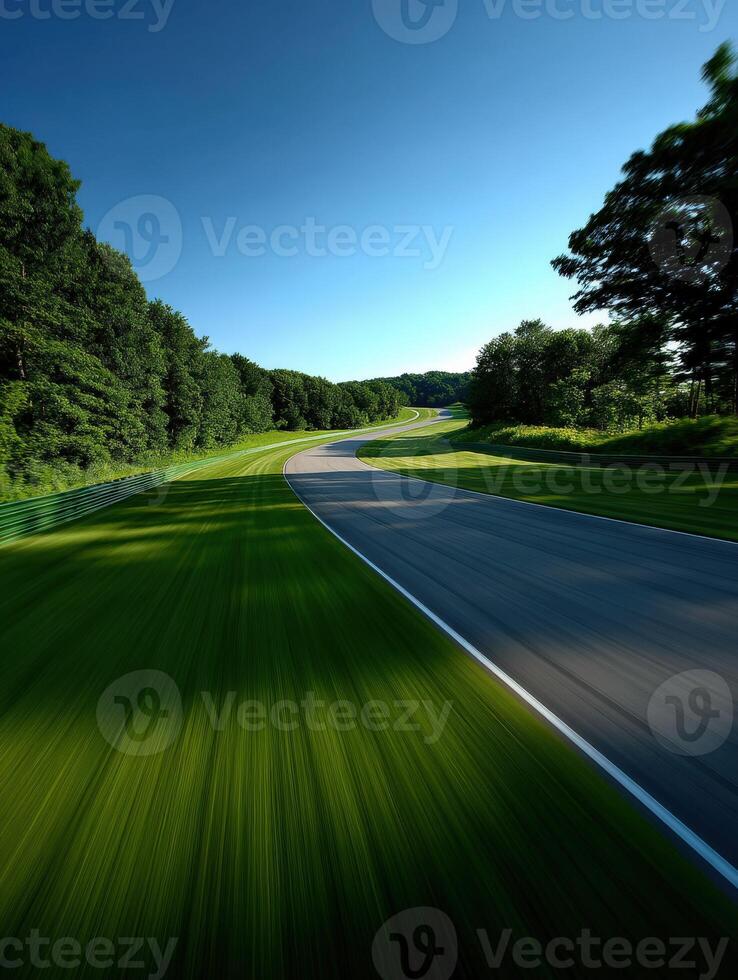Curved road through green landscape on a sunny day photo