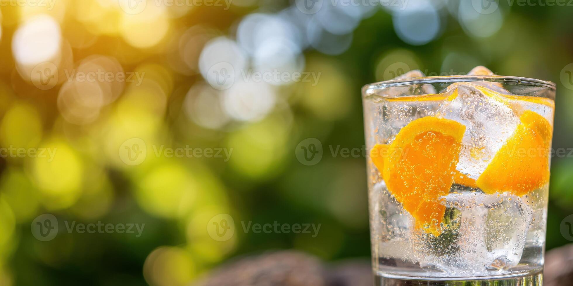 A glass of water with ice and orange slices photo