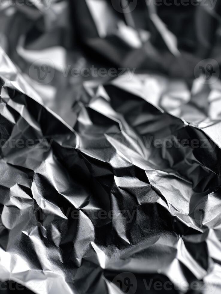 Crumpled aluminum foil with shiny texture and shadows photo