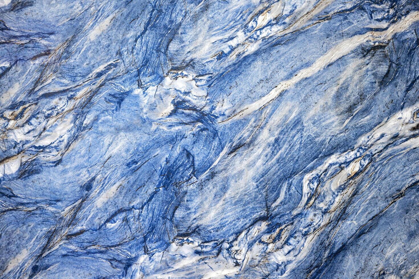 A blue marble surface with white and black paint photo