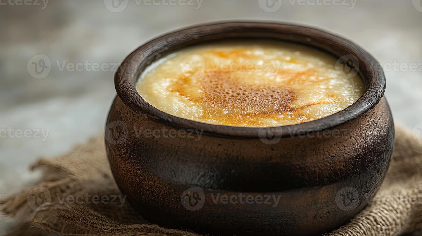 A brown pot with a spoon of something in it photo
