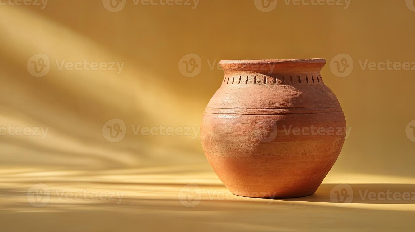 Clay Vase on Yellow Background with Warm Shadows photo