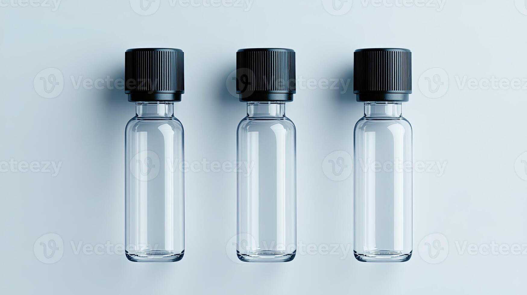 Three Empty Glass Bottles with Black Caps for Display photo
