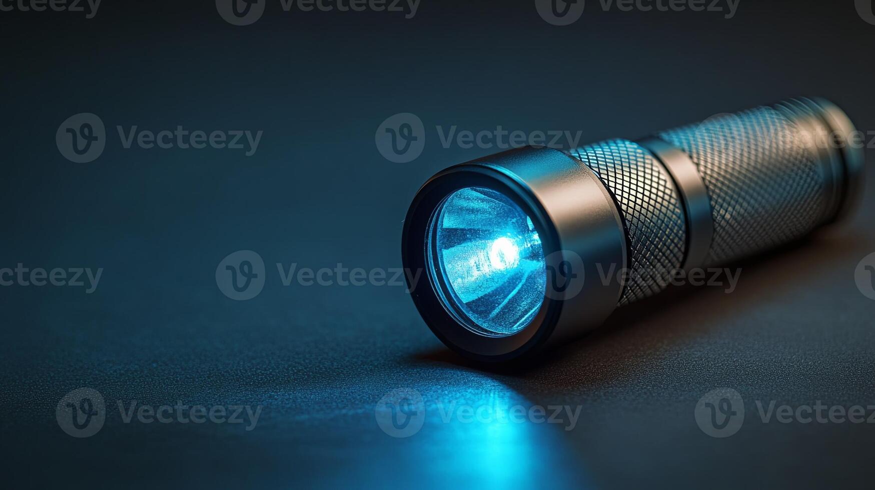 A flashlight with blue light shining through it photo