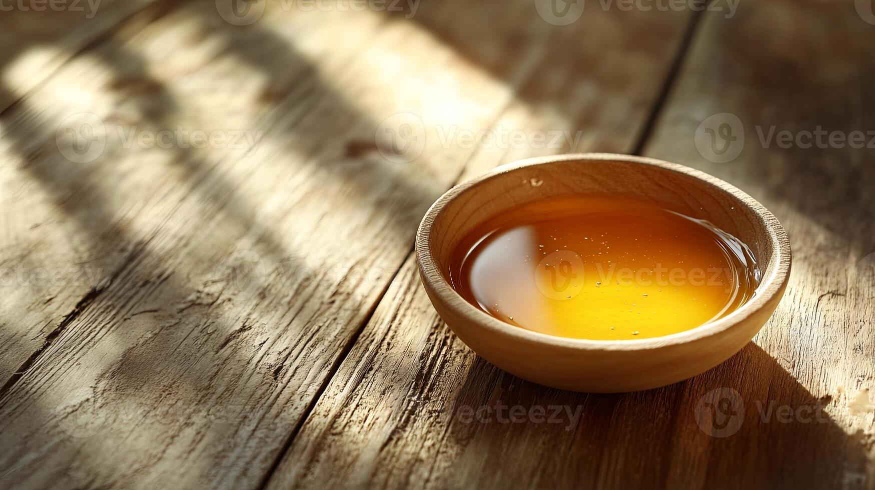 A bowl of tea sits on a wooden table photo