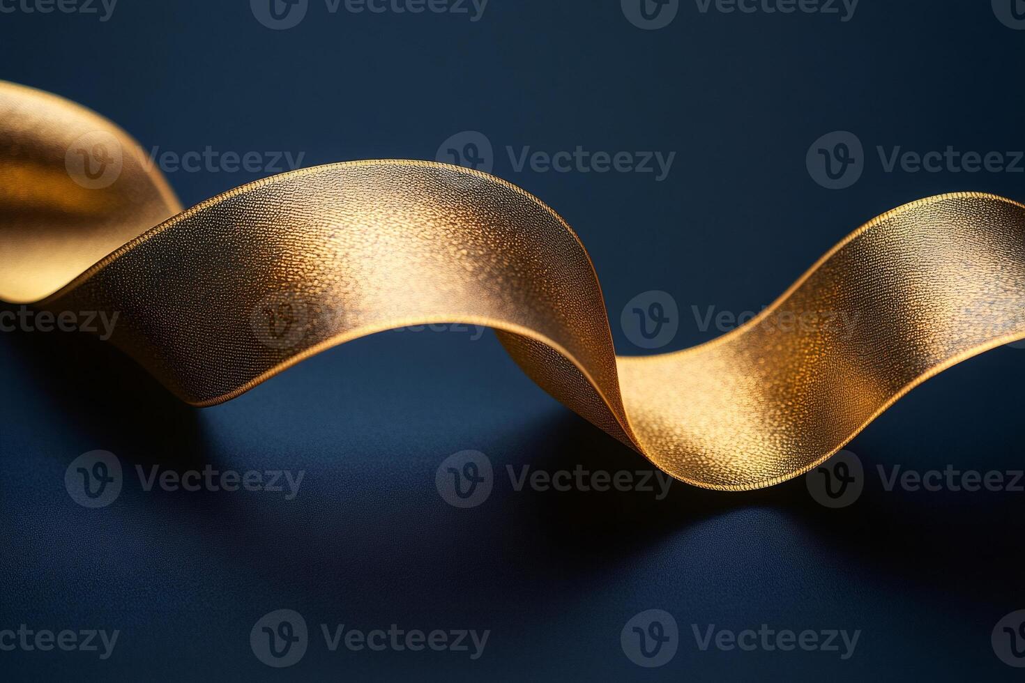 Golden ribbon waving on dark blue background creating elegant composition photo