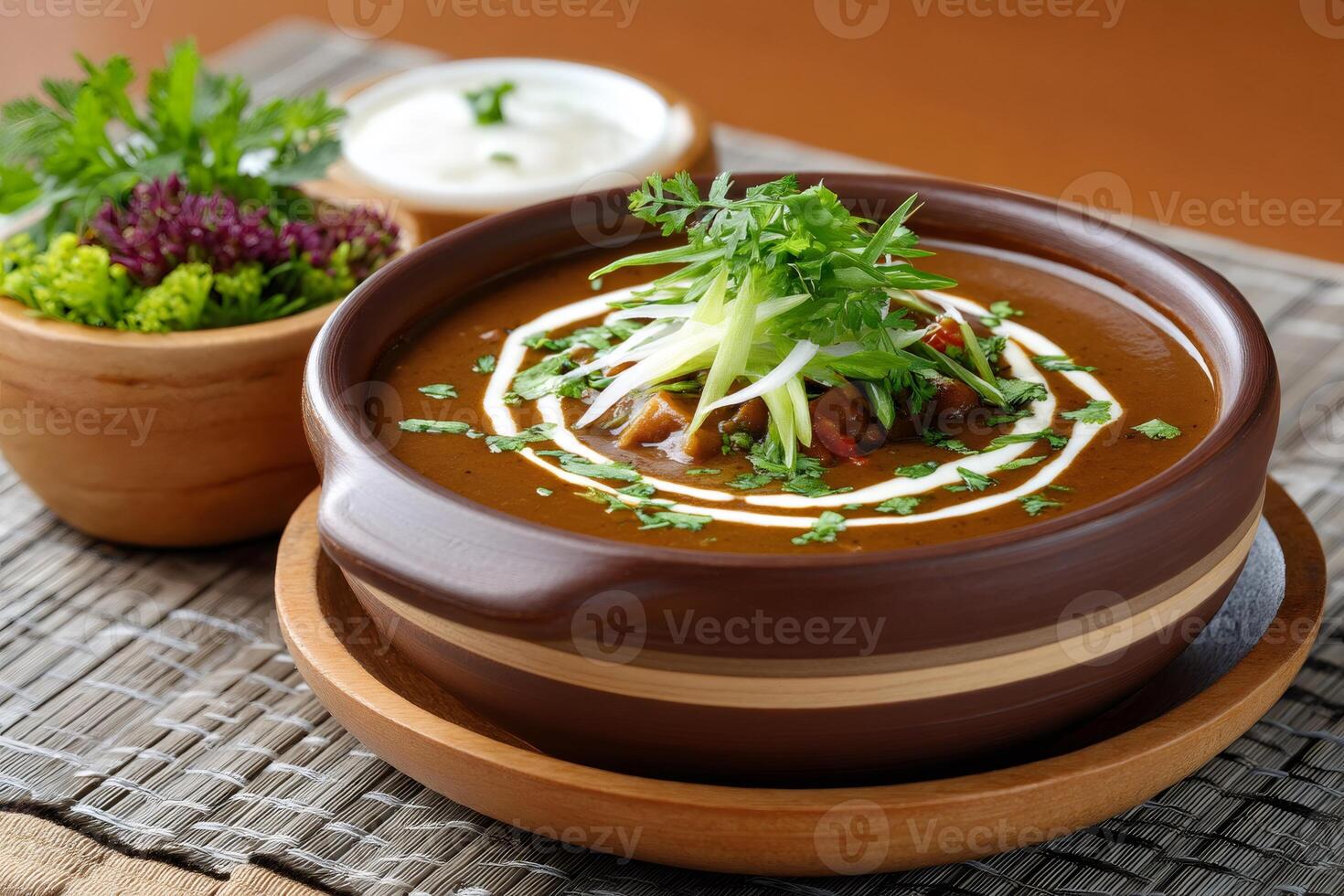 Delicious stew garnished with sour cream and herbs served in rustic bowl photo
