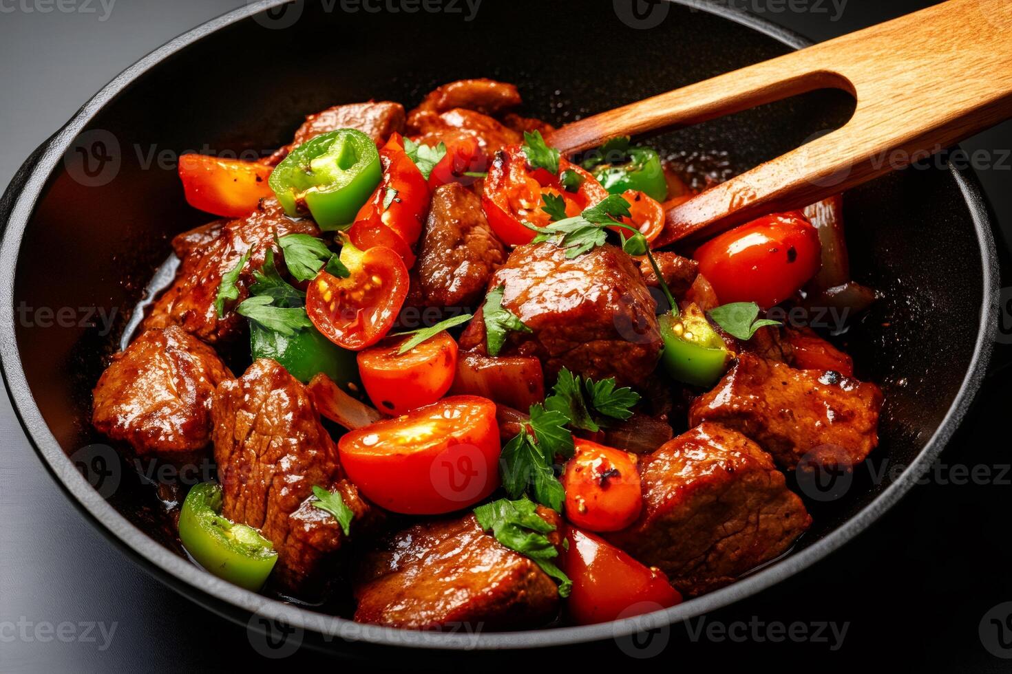 Chef preparing delicious beef stew with tomatoes, peppers and parsley in a pan photo
