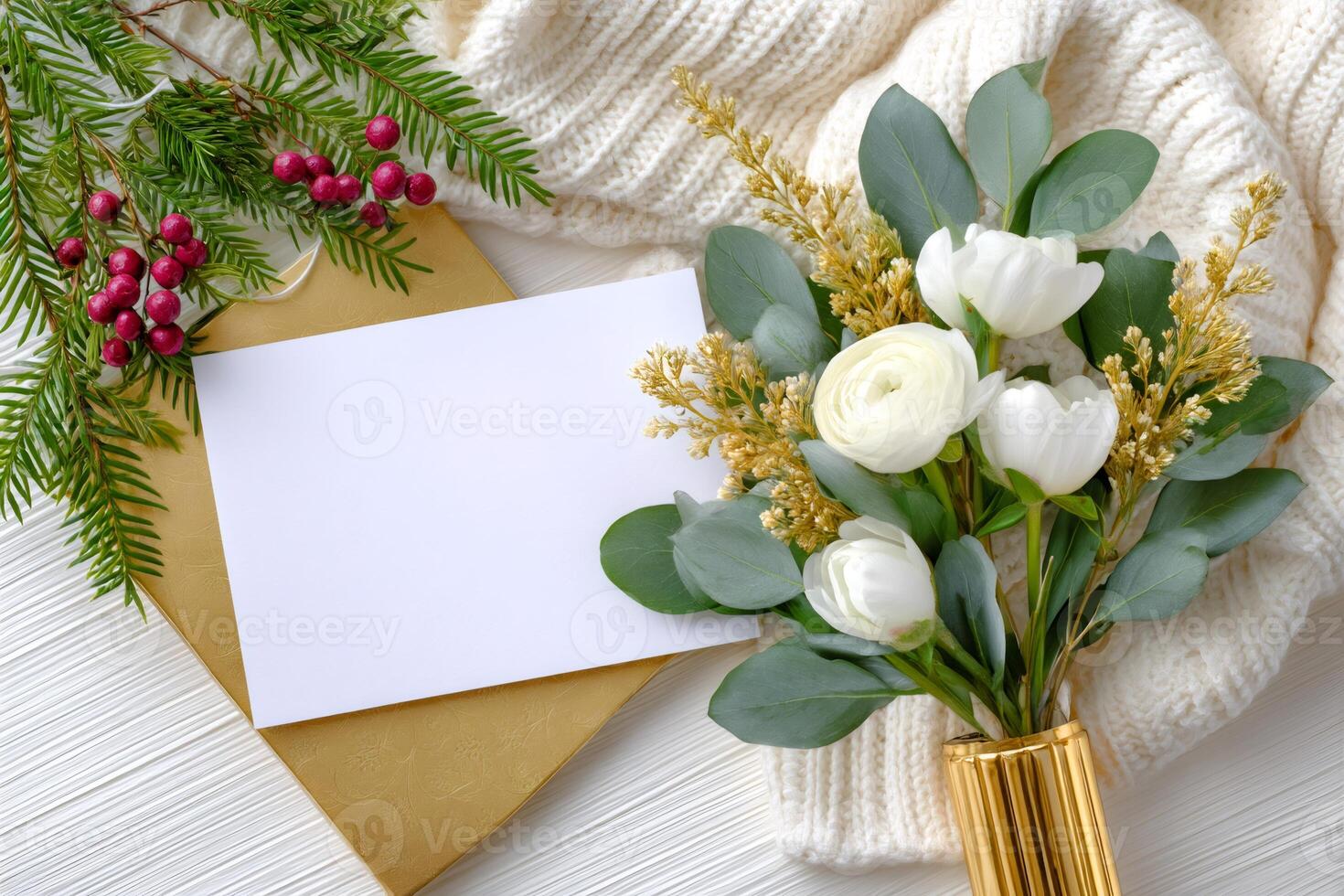 Christmas card mockup with white flowers, golden decorations and knitted sweater on white wooden table photo