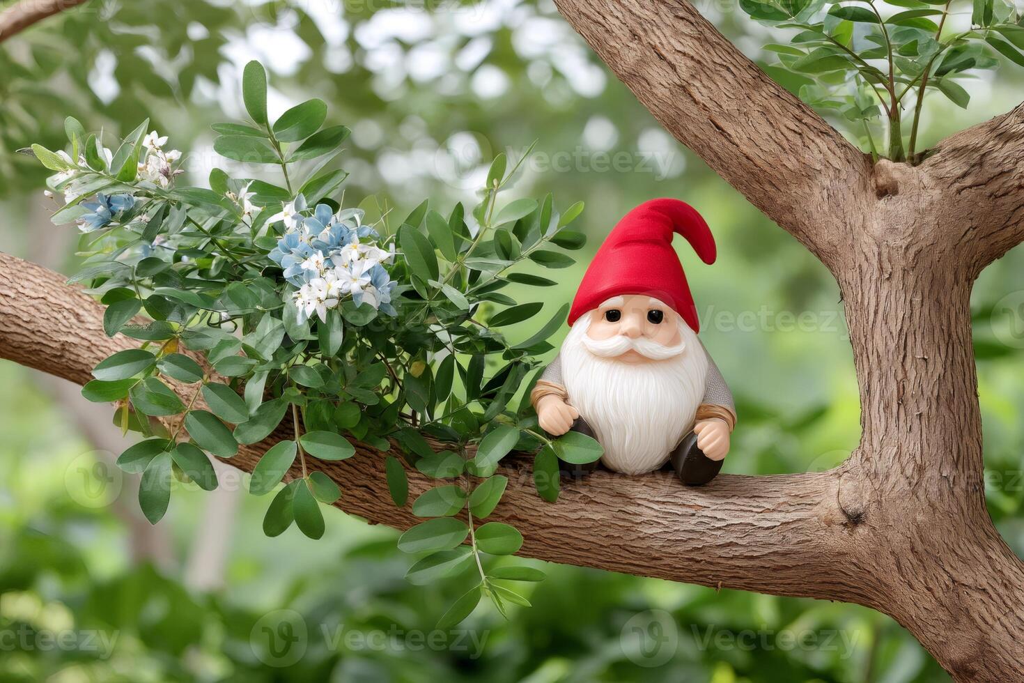 Garden gnome sitting on a tree branch enjoying nature photo