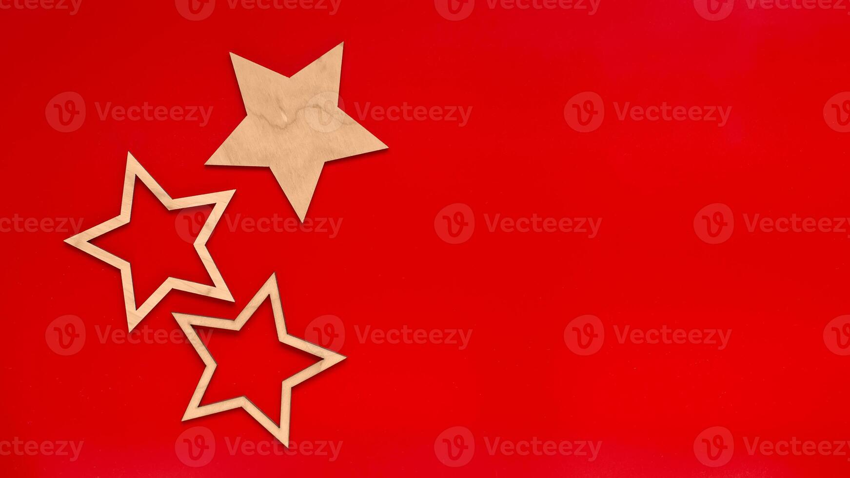 Wide banner Red background with three flat wooden stars. photo