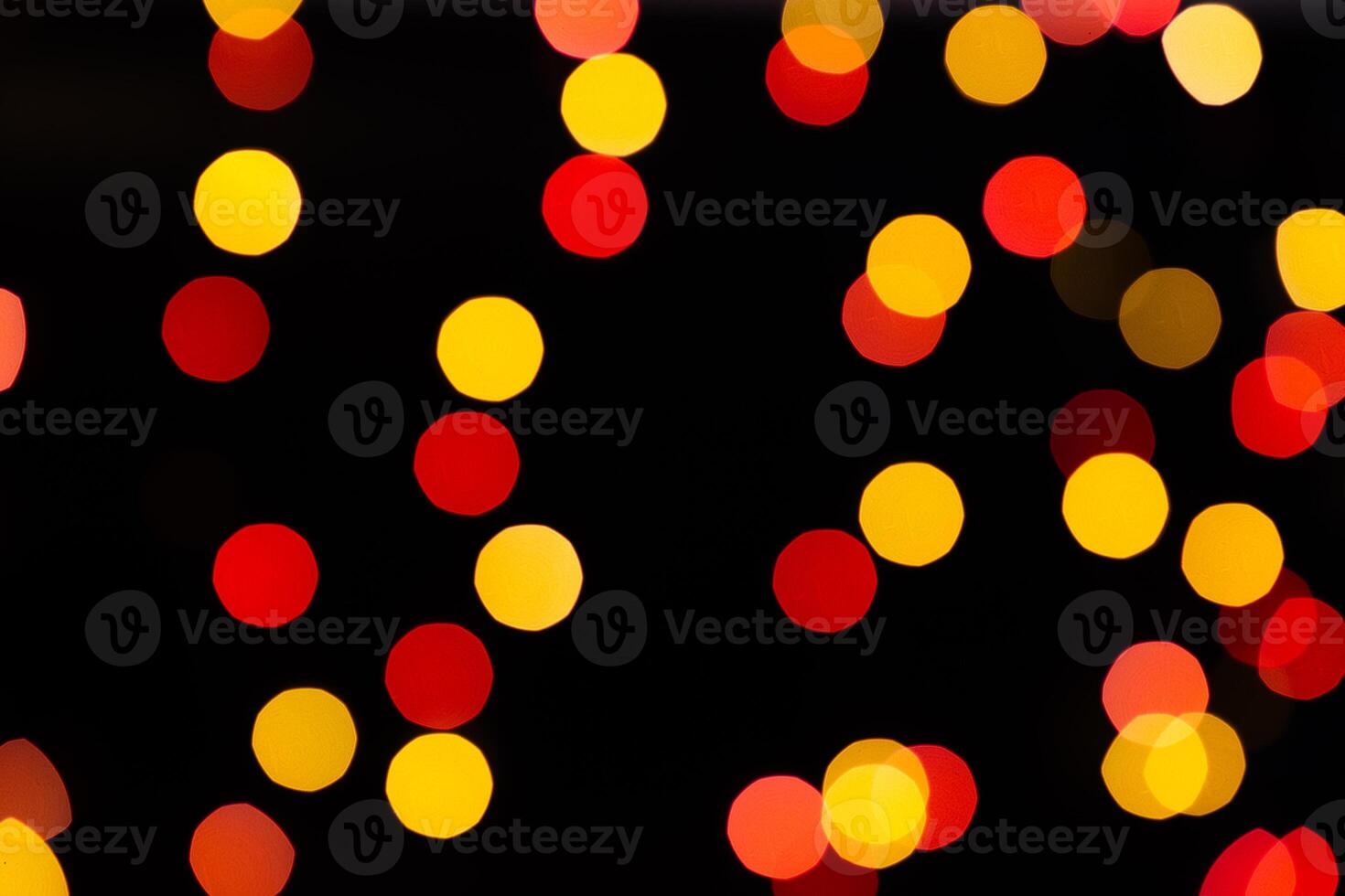 Red and orange bokeh from glowing garlands on a black background. photo