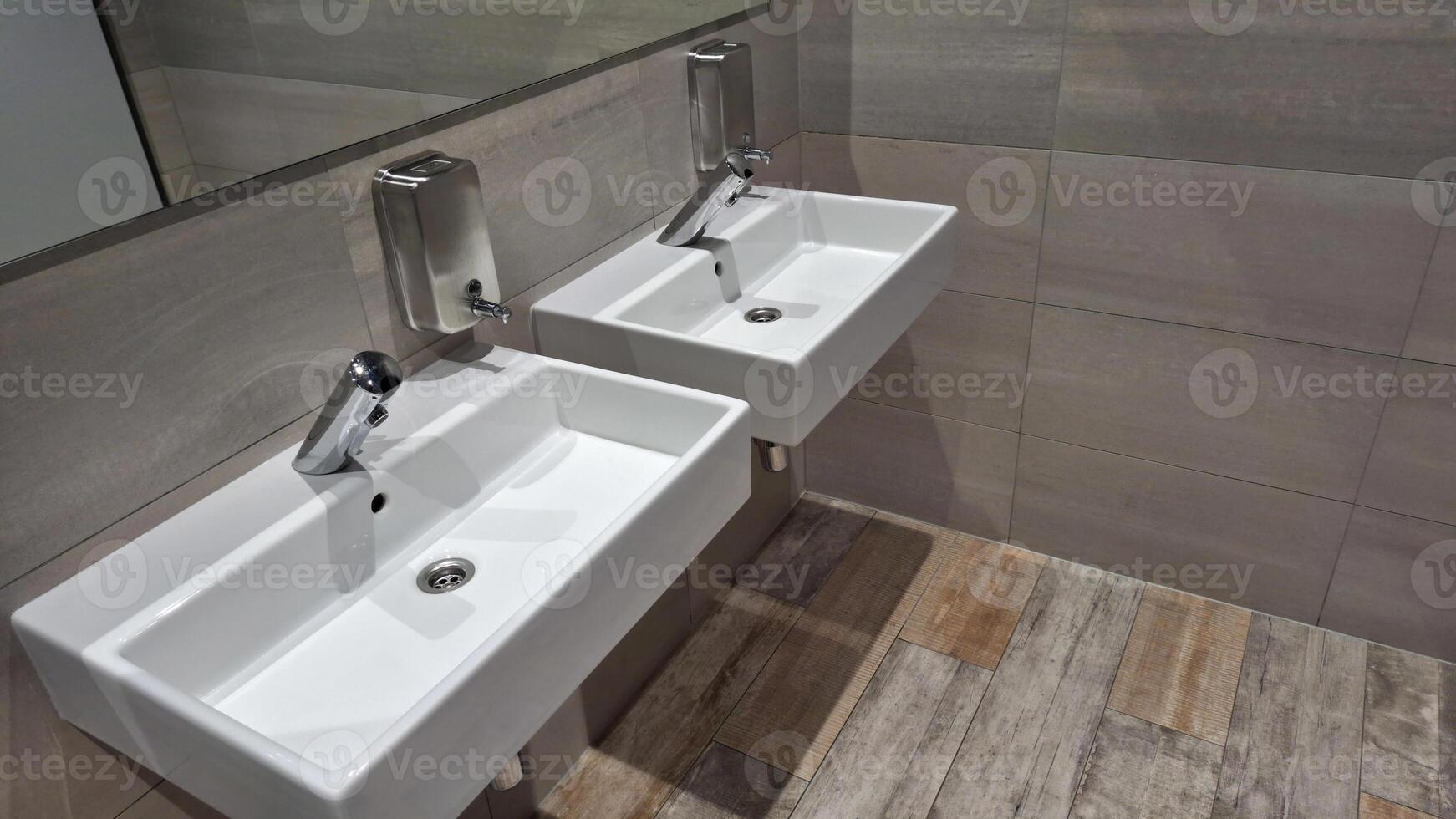 Modern bathroom with twin sinks and soap dispensers in minimalist design photo