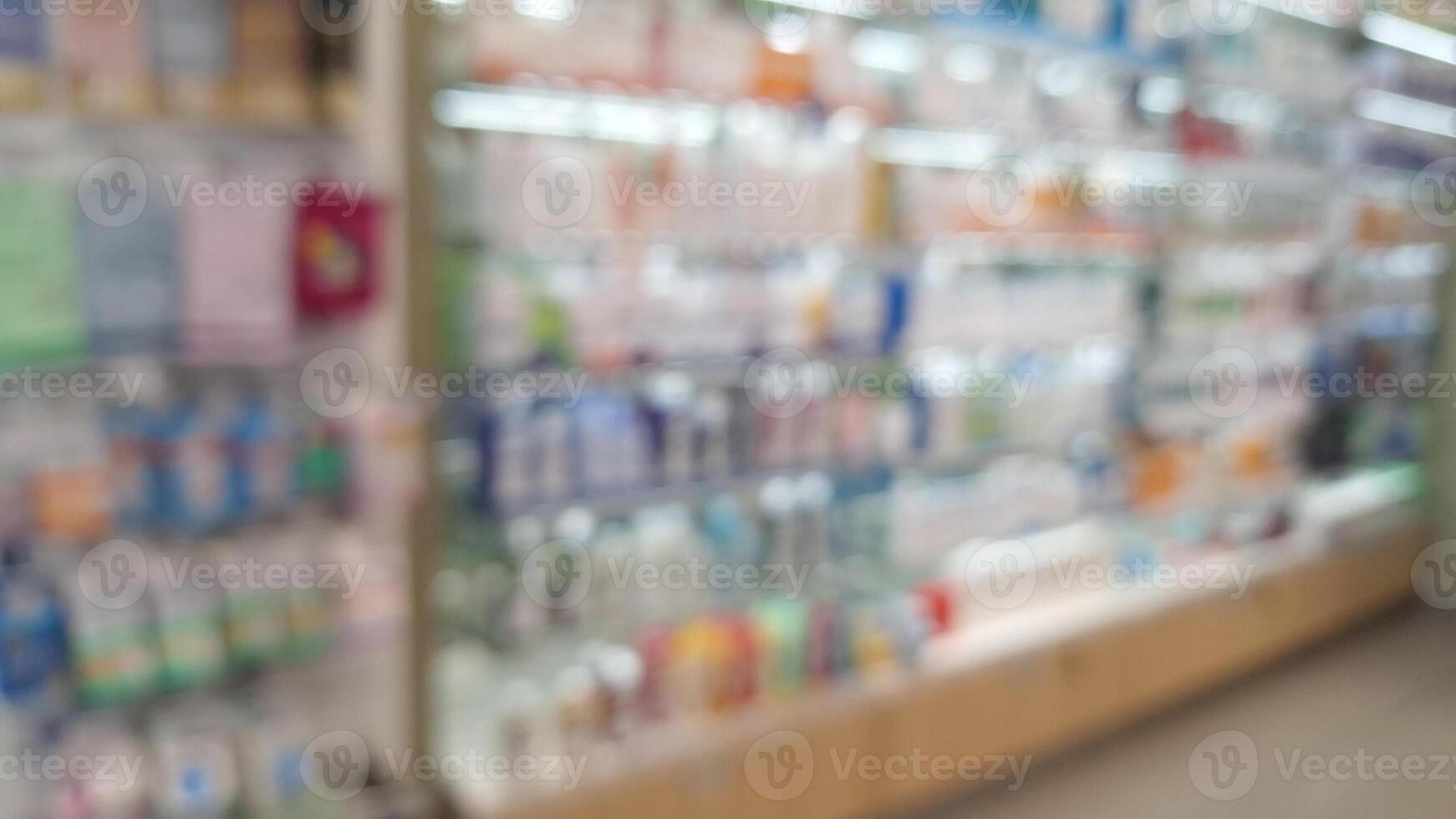 Blurred view of colorful pharmacy shelf display . photo