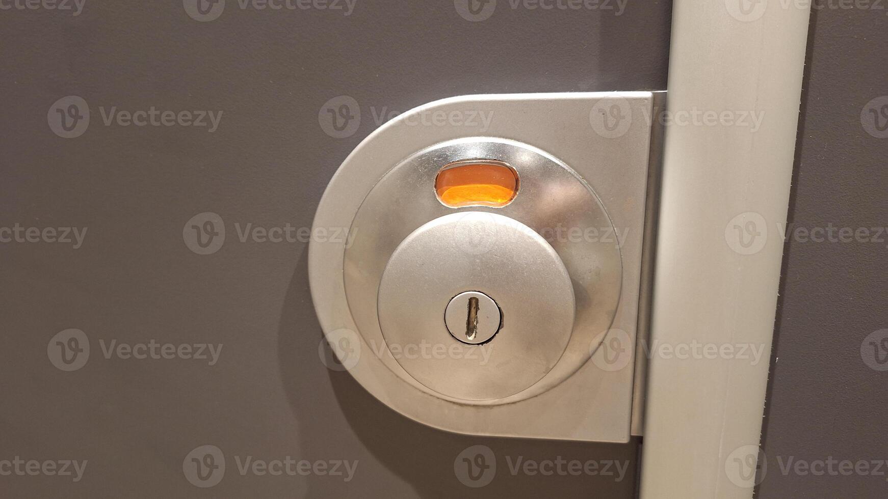 Secure metallic door lock mechanism with keyhole on gray surface photo