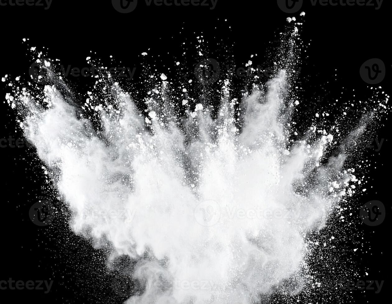 Powder explosion from center over solid black background photo